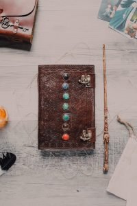 Seven Chakra Stone Book Beside Magic Wand